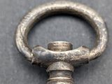 a close up of a silver pocket watch on a table