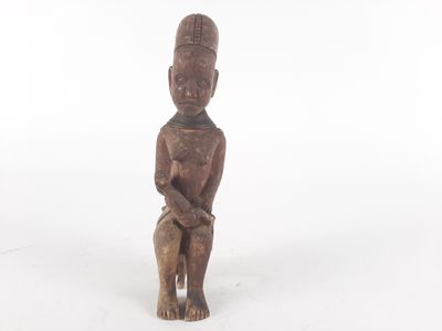 an old wooden statue of a man holding a baby