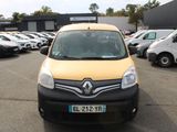 a yellow van parked in a parking lot with other cars