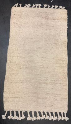 a close up of a white rug on a black background