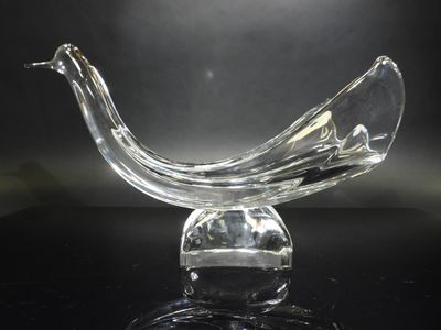 a glass bird that is sitting on top of a table