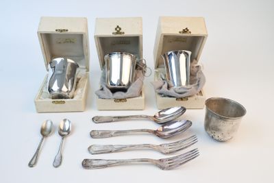 four silverware pieces in a wooden box with a spoon and spoon rest