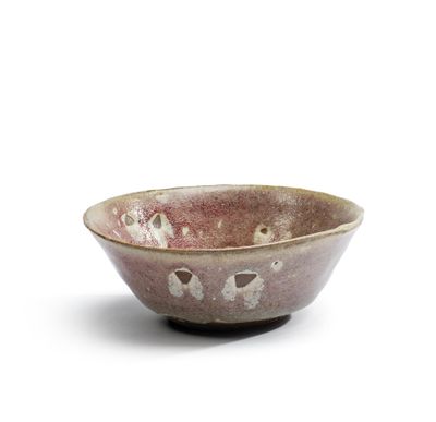 a close up of a small bowl on a white surface