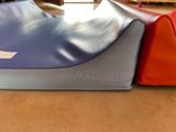 two bags sitting on the floor next to each other