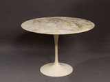 a white table with a marble top on a grey background