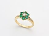 an emerald and diamond cluster ring