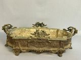 brass plated planter with flowers and leaves on it