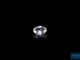 a white diamond on a black surface with a reflection
