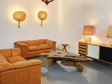 a living room with two couches, a coffee table and a lamp