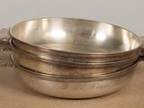 an image of a silver bowl sitting on top of a table