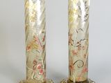 pair of gold glass vases with flowers and leaves on them