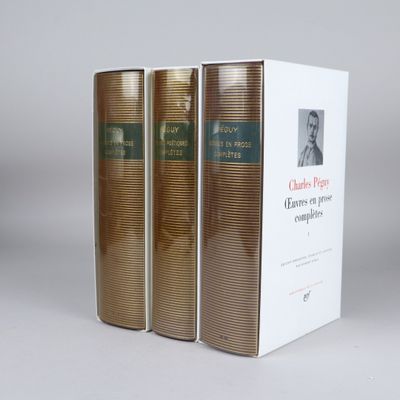 three books sitting on top of a white box on a table
