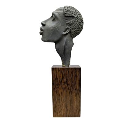 statue of a woman ' s head on a wooden base