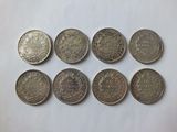 a bunch of coins sitting on top of a white surface