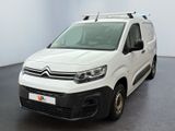 the white van is parked in a large room with a black floor