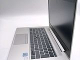 a silver laptop computer sitting on top of a white table