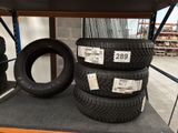 three tires are stacked on a shelf in a store