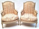 pair of upholstered chairs with striped upholstered cushions
