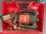 a red tool box with tools in it on the floor