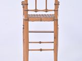 a wooden chair with a woven seat on a white background