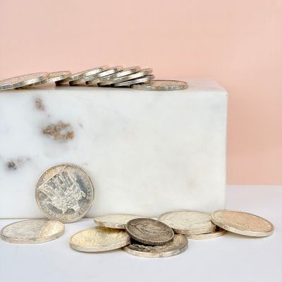 a marble block with a bunch of coins on it