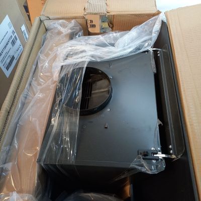 a box with a microwave inside of it that is wrapped in plastic