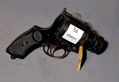 a gun with a tag on it sitting on a table