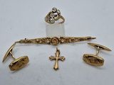 a close up of a pair of cuff rings and a cross