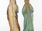 two figurines of jesus and mary standing next to each other
