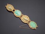 a gold and jade bracelet