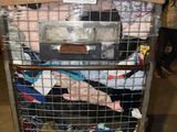 a cart full of clothes that is sitting in a warehouse