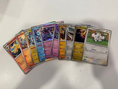 several pokemon cards are lined up on a white surface
