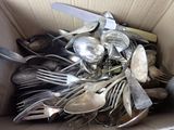 a box full of silver spoons and spoons in it