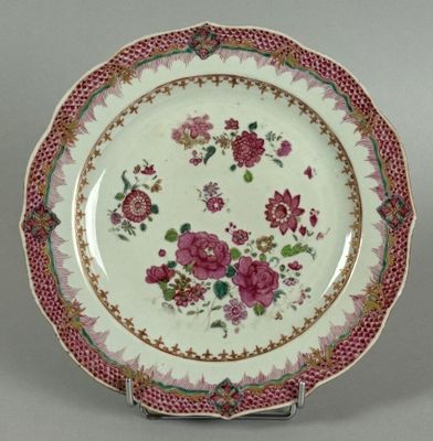 an image of a plate with flowers on it on a stand