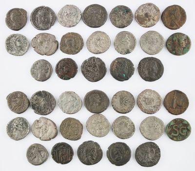 an assortment of ancient roman coins on a white surface