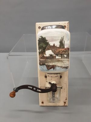 a glass jar with a picture of a house in it