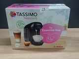 a box of tassimo coffee machine sitting on top of a wooden table