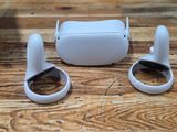 a pair of white ear buds sitting on a wooden table