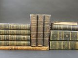 several old books stacked on top of each other on a table