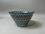 a small bowl sitting on a table with a white background