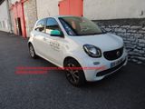 smart car parked in front of a building with a red door