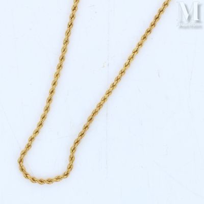 a close up of a gold chain on a white background
