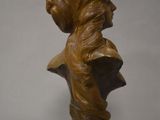 a close up of a statue of a woman on a pedestal