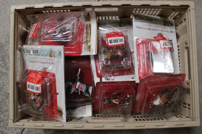 a box full of assorted toys in it on the floor