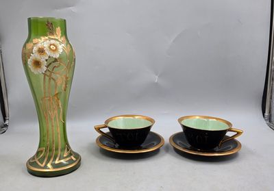 two cups and a vase sitting on a table