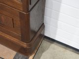 a wooden clock on top of a wooden stand
