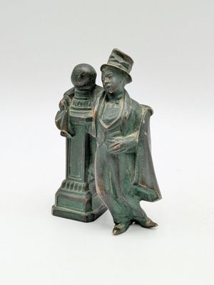 bronze figurine of a man and a woman standing next to each other