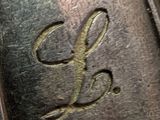 a close up of a metal object with a monogram on it