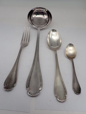 four spoons and a fork on a table