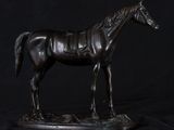 a statue of a horse that is standing on a table